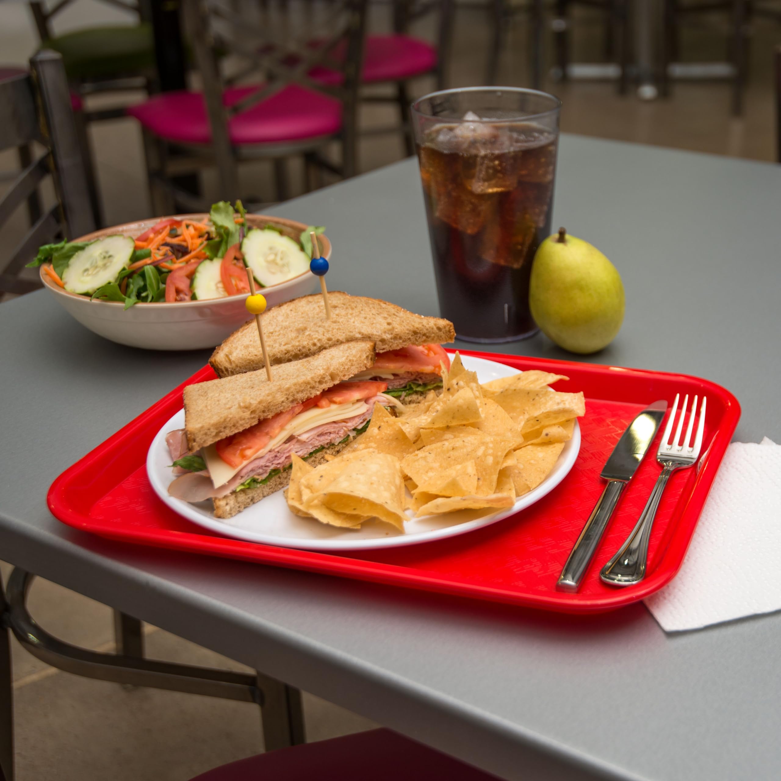 Carlisle tray carrying a full meal in a restaurant setting for reliable handling