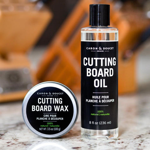 Caron & Doucet pouring coconut-based oil onto a cutting board for deep conditioning