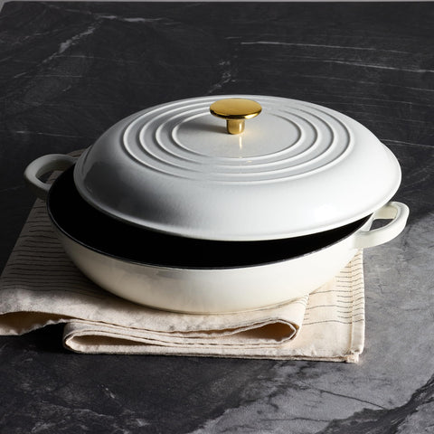CAROTE braiser beside wooden spoon showing size and capacity, practical kitchen fit