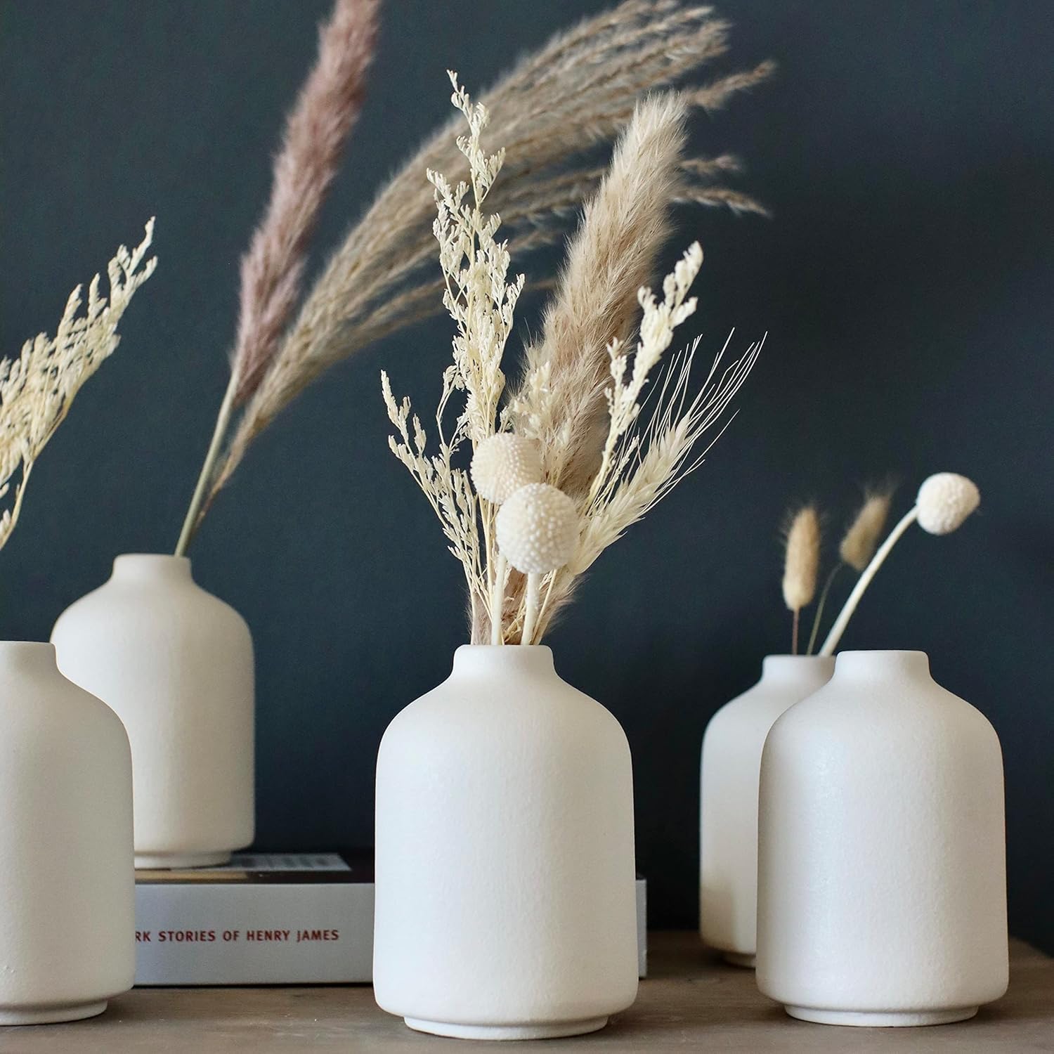 Carrot's Den front view of six white ceramic bud vases showing clean minimalist design and benefit of cohesive set