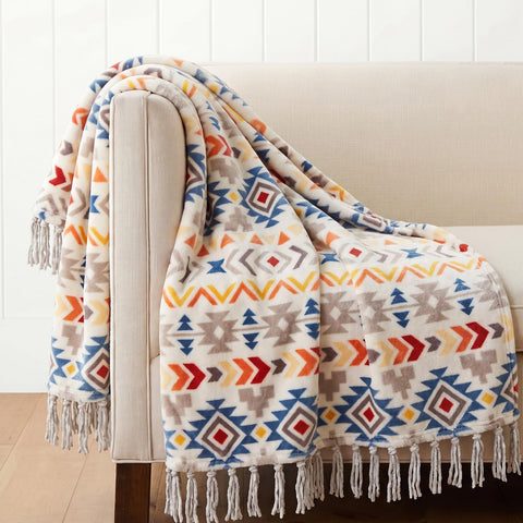 CASAAGUSTO front view showing colorful boho throw and tassels for instant style