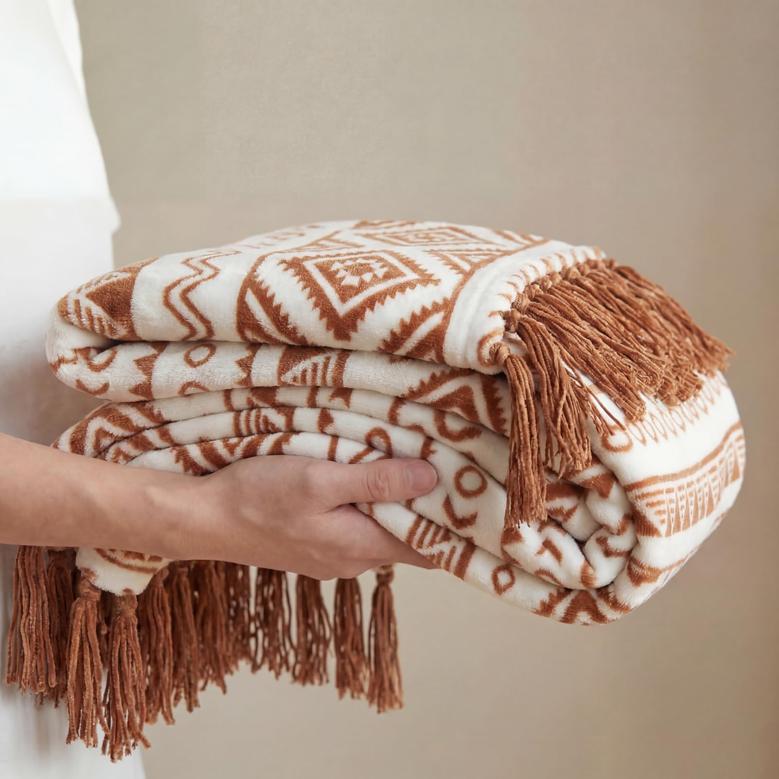 CASAAGUSTO throw draped over sofa adding warm layered decor