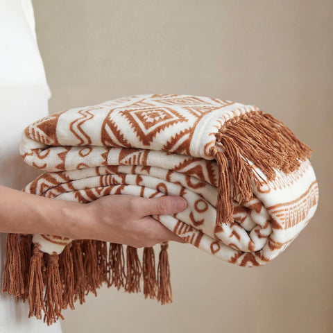 CASAAGUSTO throw draped over sofa adding warm layered decor