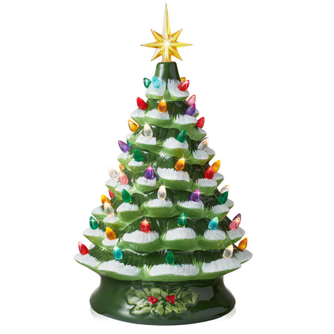 Casafield front view of green snow flocked tree showing festive glow