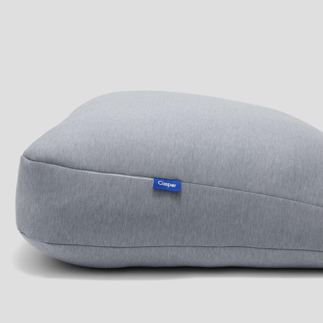 casper pillow behind sitter supporting back while reading in bed