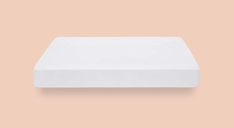 Casper protector on a made bed illustrating clean look and spill protection