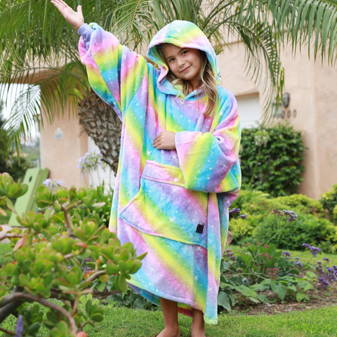 Child wearing Catalonia hoodie blanket outdoors showing mobility and warmth benefit