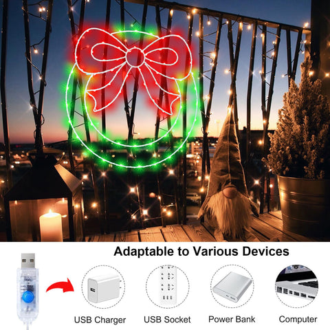 CESOF wreath mounted in a window at night showing bright red and green LEDs for curb appeal