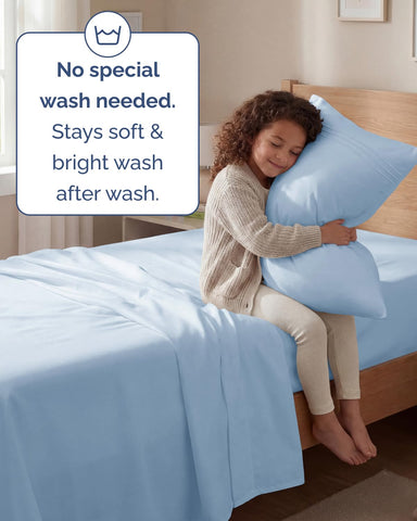 Bedroom scene with CGK Unlimited sky blue sheets creating a calm, inviting sleep space