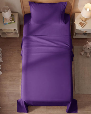 CGK Unlimited styled bedroom with purple sheets creating a cozy, modern vibe