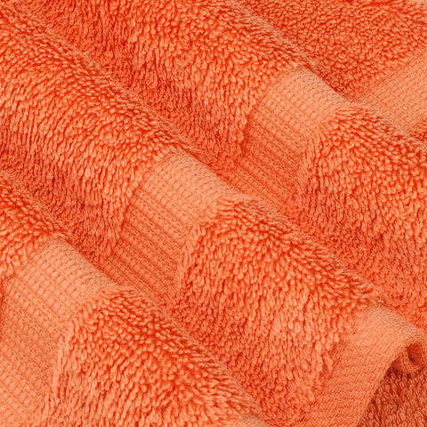 Chakir Turkish Linens coral towels displayed in a styled bathroom to show decor-friendly color and use