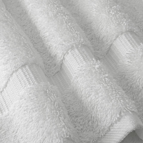 Chakir Turkish Linens towel held by hand to show 27x54 inch size and full coverage
