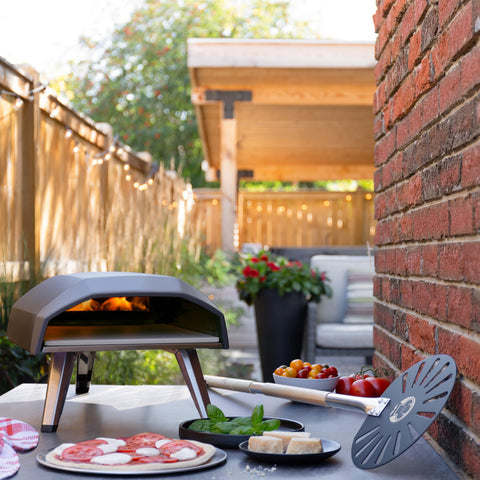 Chef Pomodoro turning pizza inside oven to ensure even browning and rotation