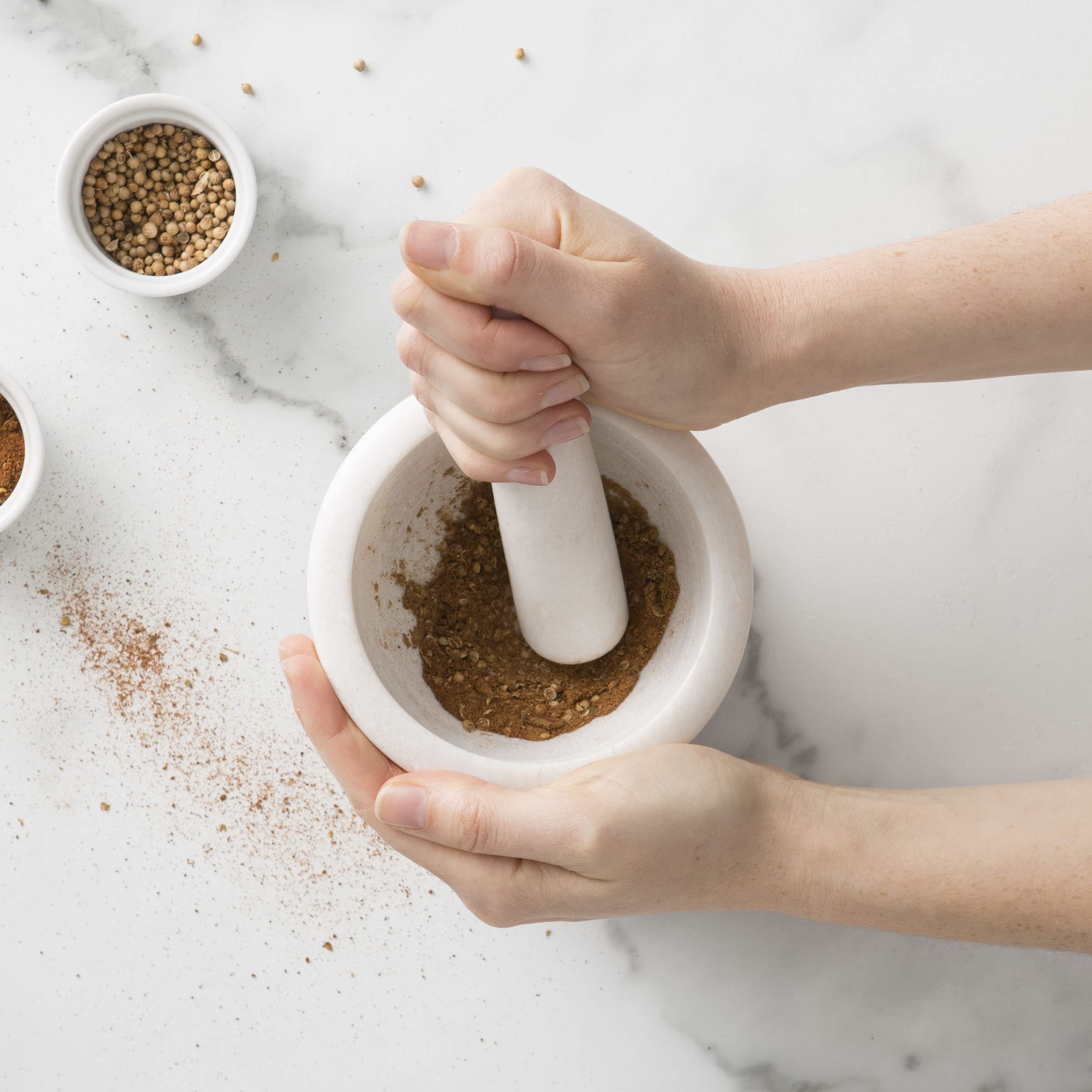 Chef'n mortar beside utensils showing compact size and easy countertop storage