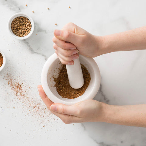 Chef'n mortar beside utensils showing compact size and easy countertop storage