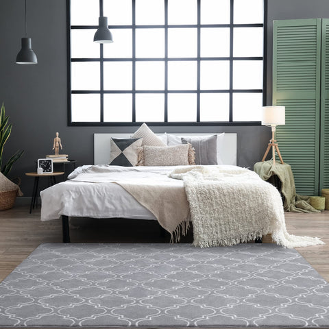 Chicrug styled beside a bed illustrating cozy bedside warmth and decor boost