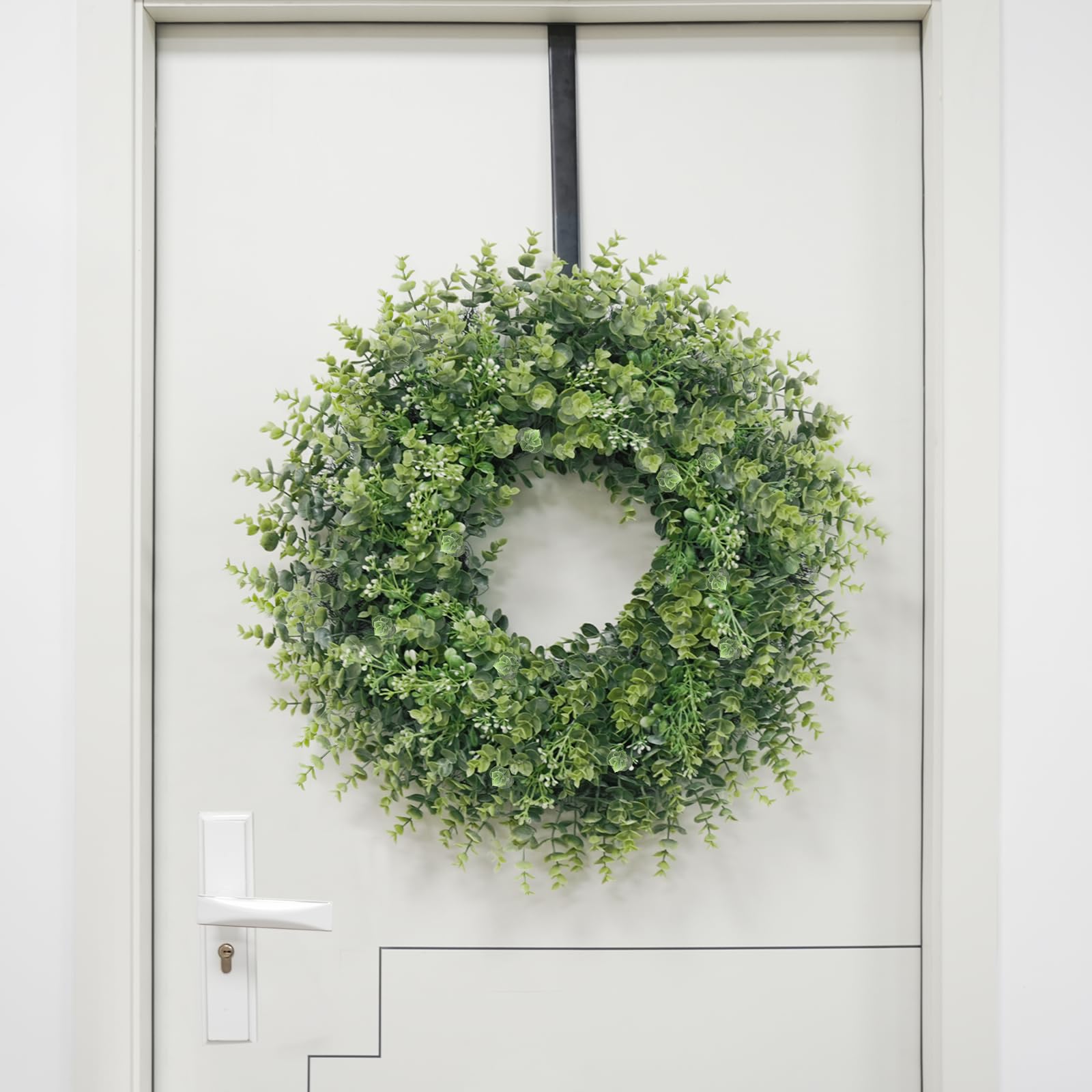 Chiyinbao wreath next to door for scale showing ideal 26–28 inch fit