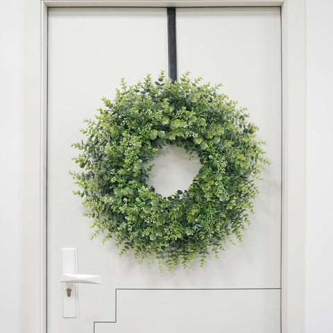 Chiyinbao wreath next to door for scale showing ideal 26–28 inch fit