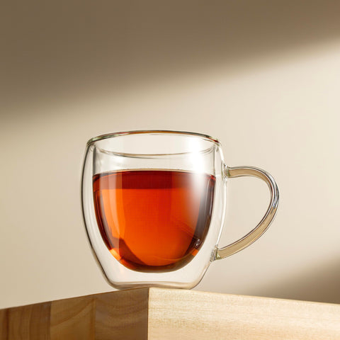 CNGLASS in-use espresso pour into mug highlighting preserved crema and pouring control
