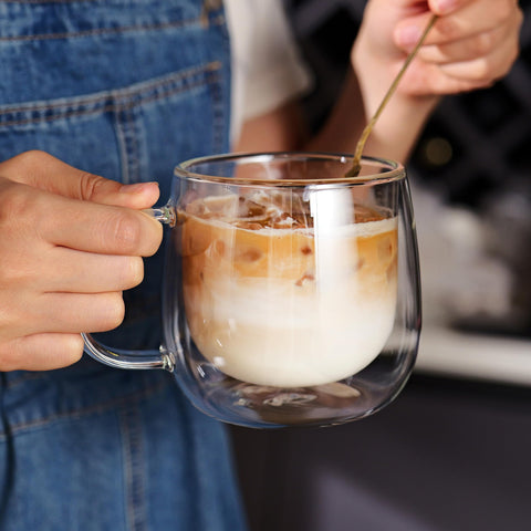 CNGLASS mug held in hand illustrating 16oz capacity and scale