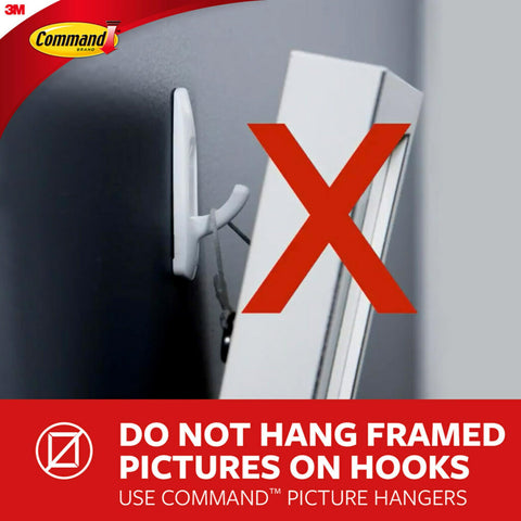 Command hook beside a coin for scale showing compact size and discreet look
