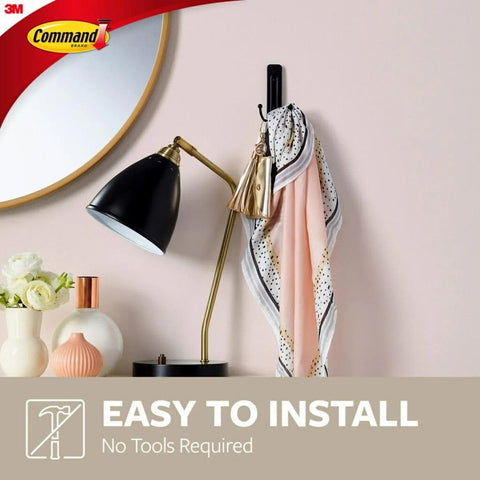 Command hook in use on entryway wall holding coats and bags, maximizes space