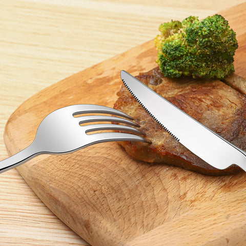 Compralo flatware next to a hand demonstrating real size and comfortable heft