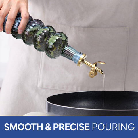 COOK WITH COLOR pouring olive oil from cruet into pan for controlled, mess-free use