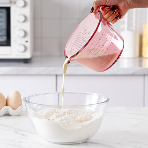 COOK WITH COLOR measuring cup in use stirring batter, convenient one-vessel prep benefit