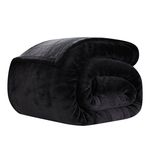 COOVA folded blanket beside pillows showing scale and portability