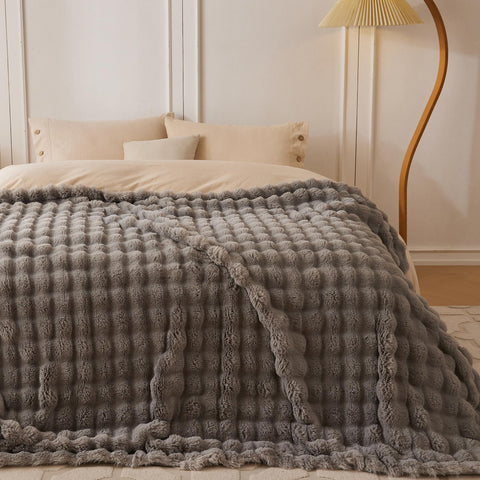 COOVA throw draped on sofa in living room adding warmth and style