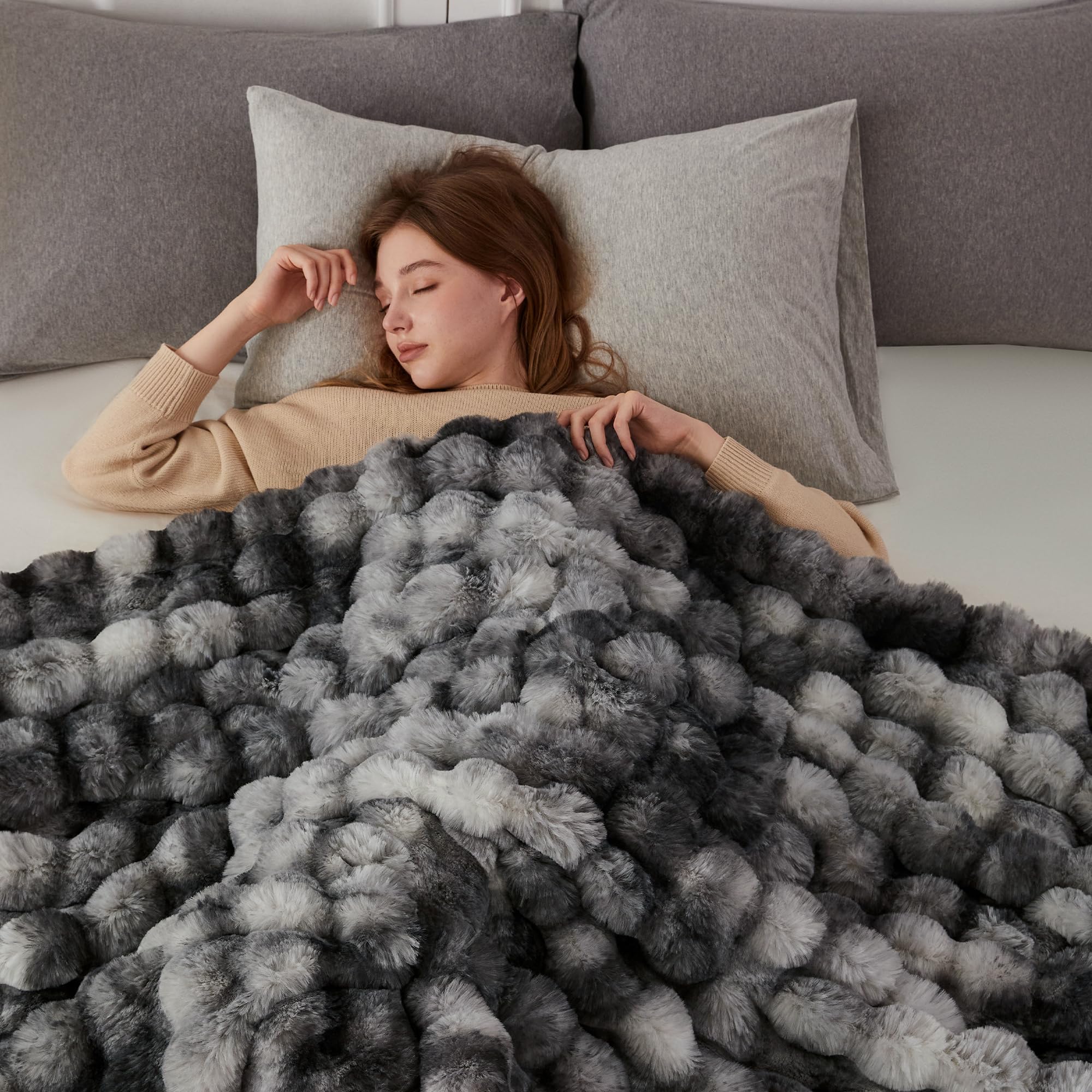 COOVA folded blanket next to book showing 60x80 inch scale and versatility