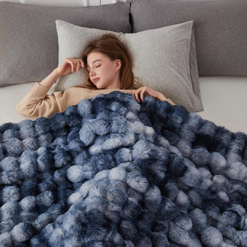 COOVA blanket on chair to show 50x60-inch scale and coverage benefit