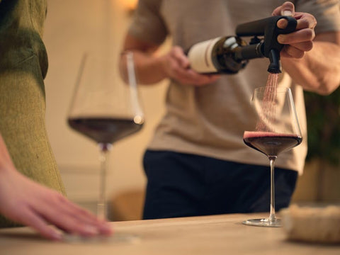 Coravin Pivot Plus in use pouring wine into glass showing controlled pour benefit