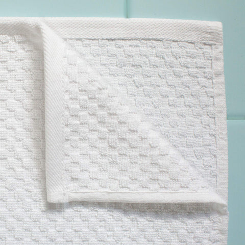COTTON CRAFT folded stack on bathroom shelf demonstrating tidy storage and coordinated style