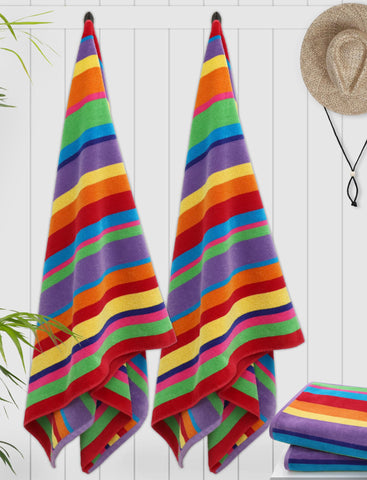 COTTON CRAFT towel spread on sand with user, demonstrates full coverage and comfort
