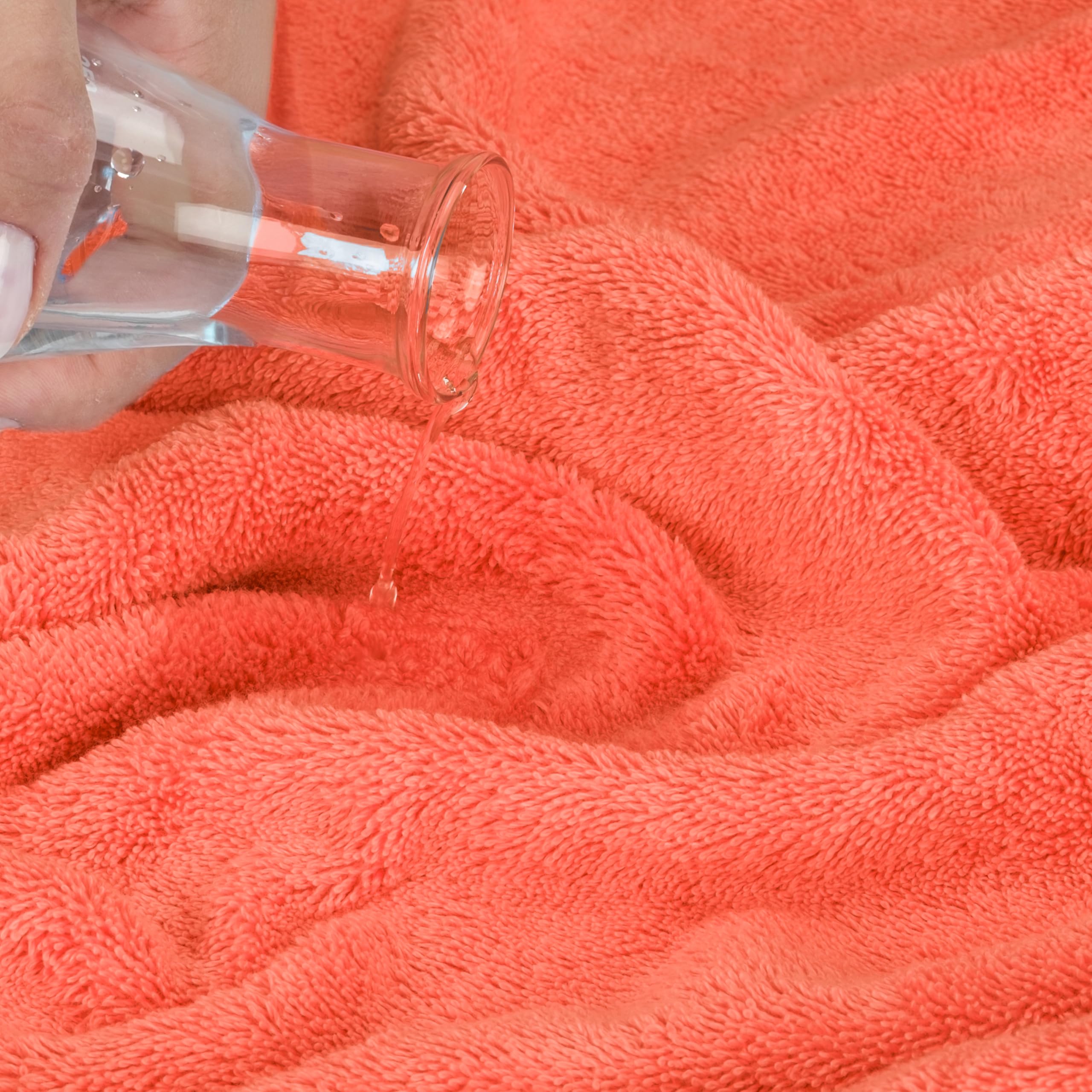 Cotton Paradise bath towel beside a book illustrating size and coverage benefit