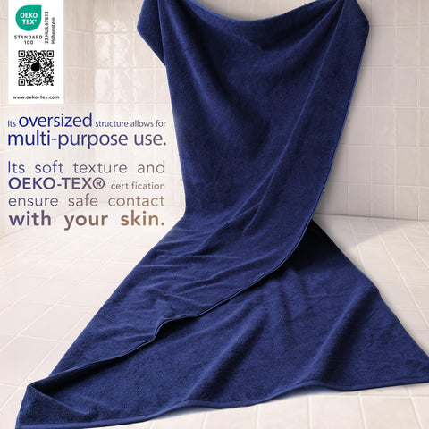 Cotton Paradise towel spread flat beside ruler showing 40x80 oversized coverage