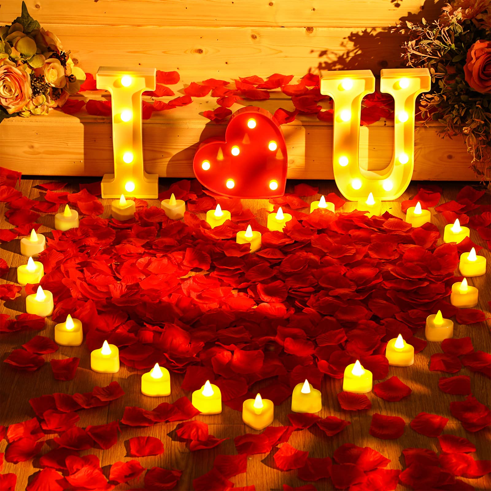 Coume candles arranged in heart on floor, focal warm-white glow