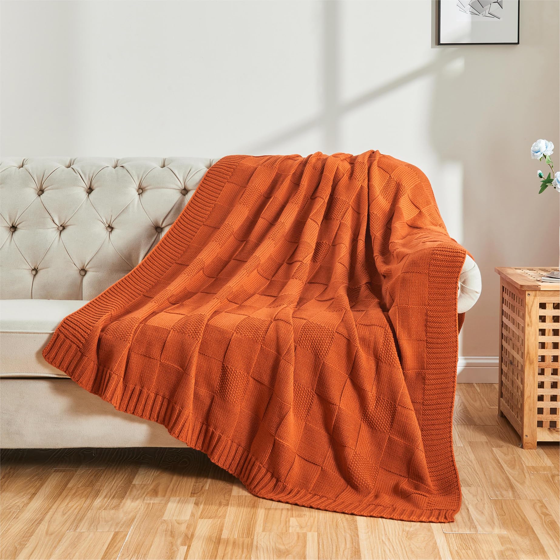 CozeCube draped over sofa lifestyle shot, adds cozy color and inviting comfort
