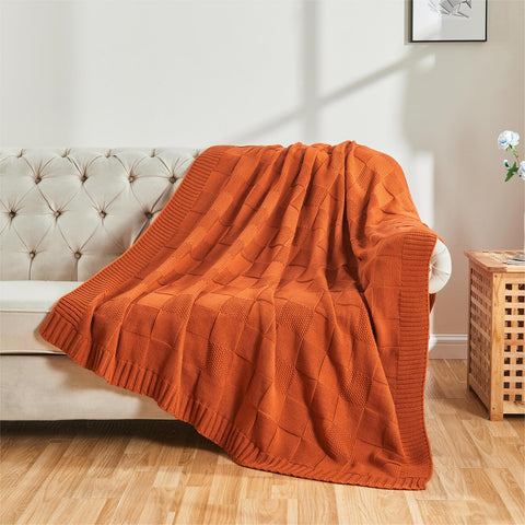 CozeCube draped over sofa lifestyle shot, adds cozy color and inviting comfort