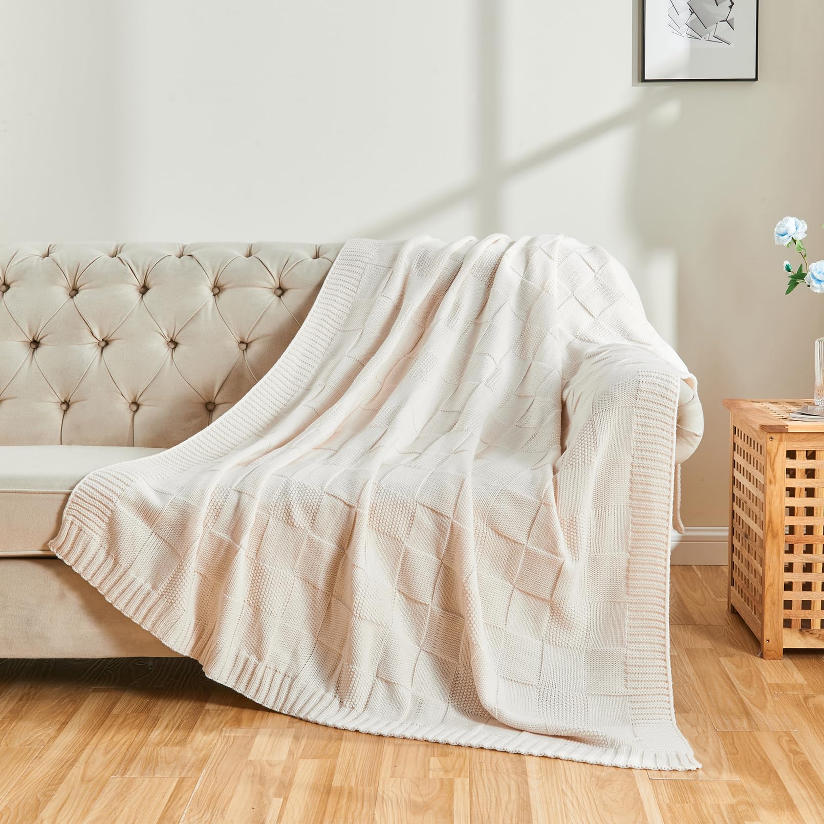 CozeCube folded throw on bed showing true 50x60 scale and neat storage convenience