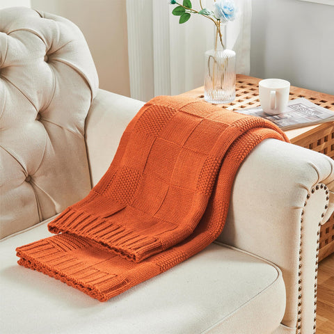 CozeCube folded at foot of bed, shows warm accent and bedroom styling benefit