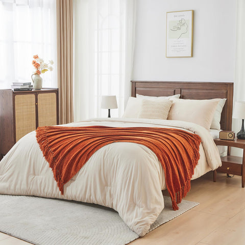 CozeCube throw layered on bed providing decorative warmth and texture