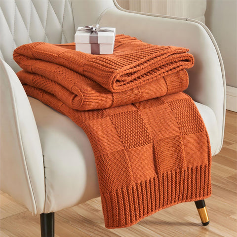 CozeCube front folded throw showing rust orange color and neat fold, enhances couch décor