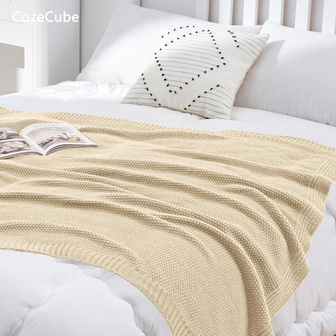 CozeCube throw beside book and mug showing size and everyday convenience
