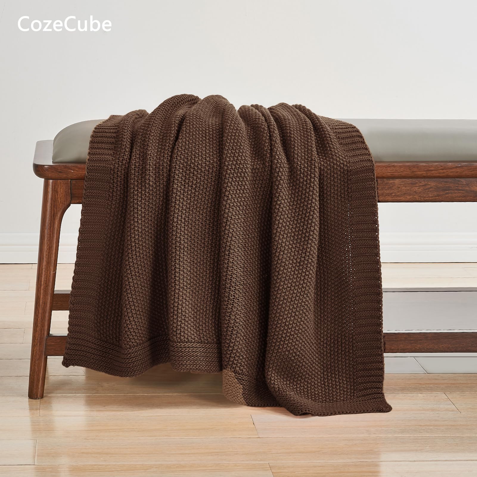 CozeCube folded throw on bed showing neutral color and neat decorative finish