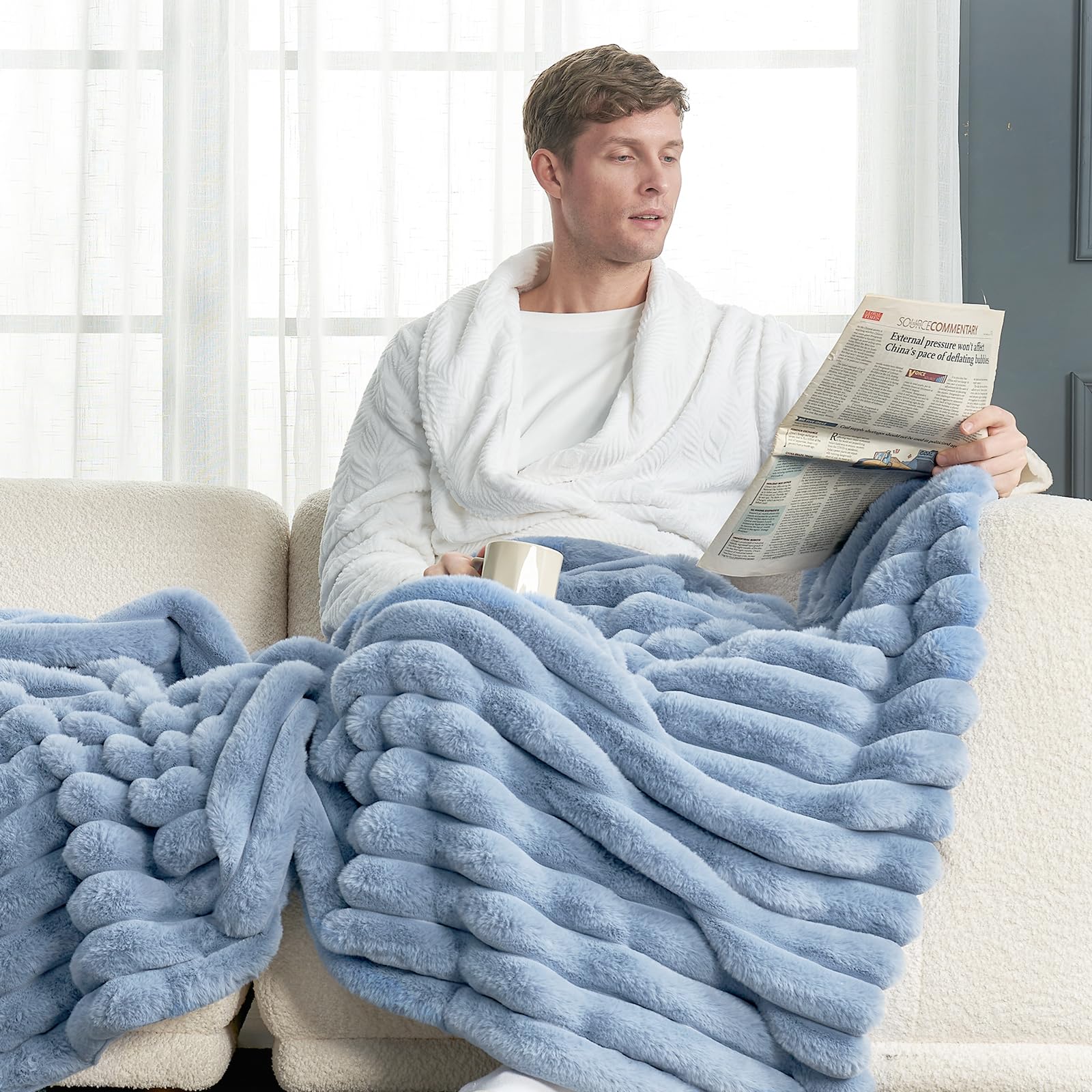 Cozy Bliss blanket draped on sofa providing warmth and style
