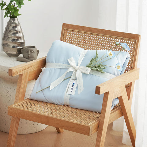 Cozy Bliss neatly folded comforter beside ruler showing compact twin dimensions for easy storage and travel