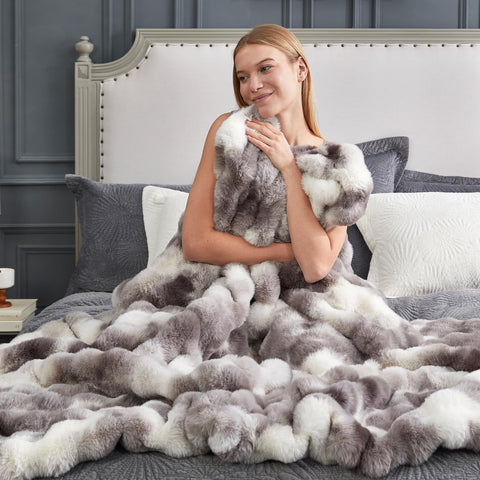 Cozy Bliss folded throw on sofa demonstrating stylish, cozy living room accent
